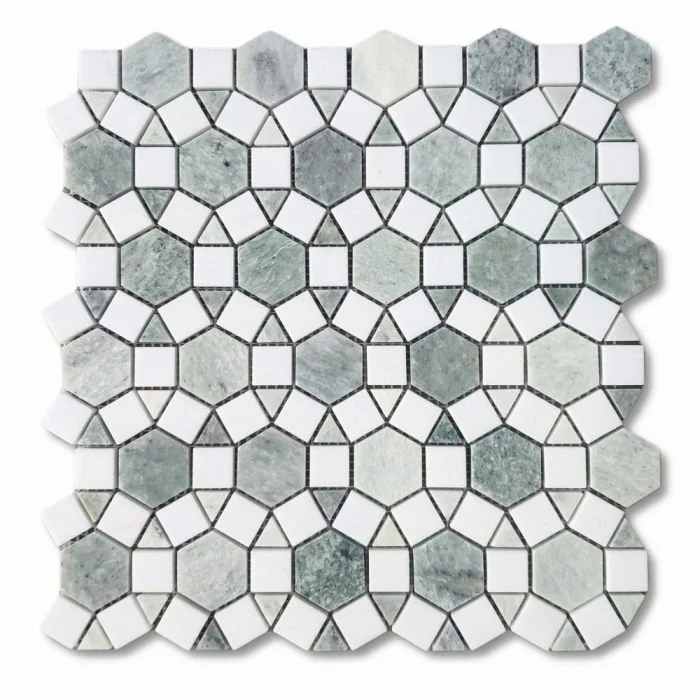 A close-up of a mosaic tile pattern with white, gray, and marbled hexagonal and pentagonal tiles separated by black grout lines.