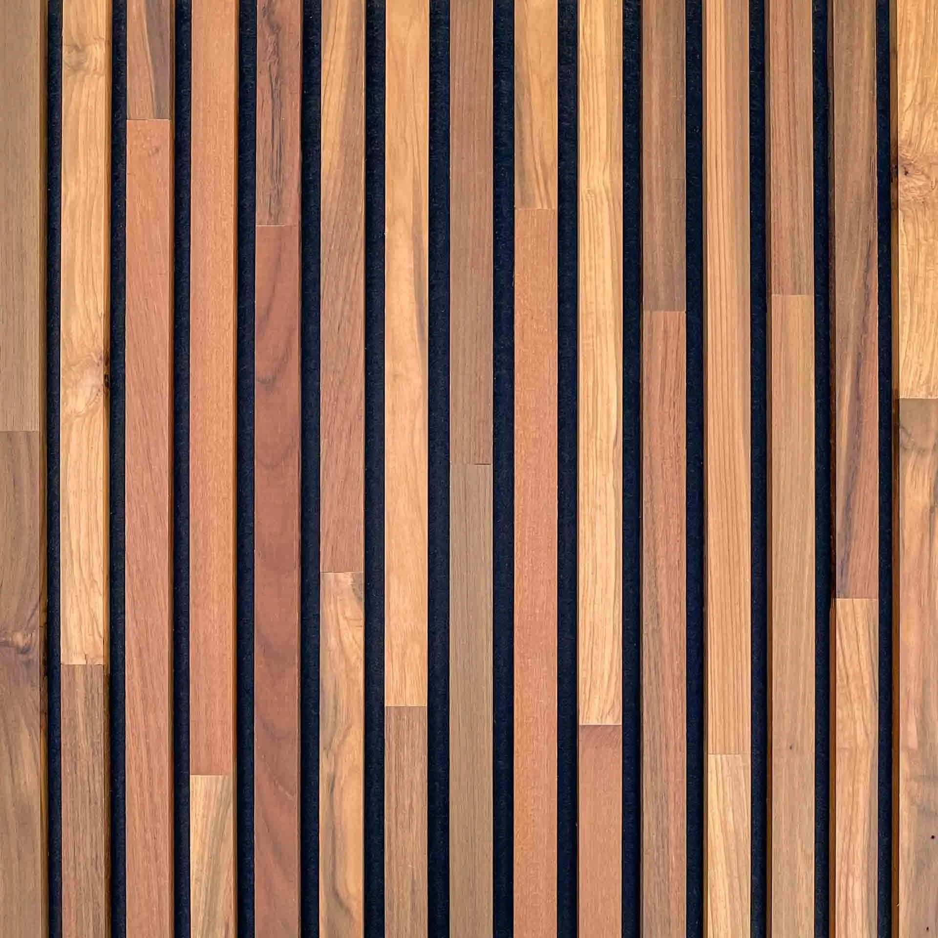 Close-up of wooden slats arranged vertically with dark gaps in between.