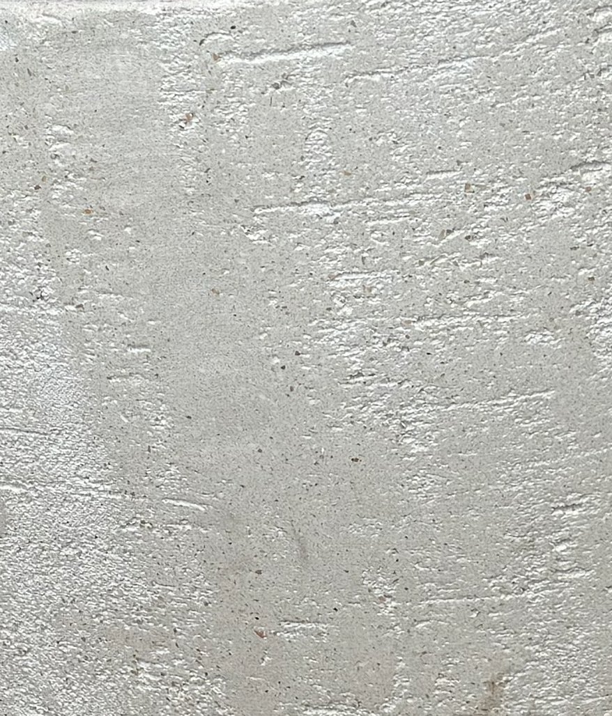 Close-up of a textured, painted concrete wall surface.