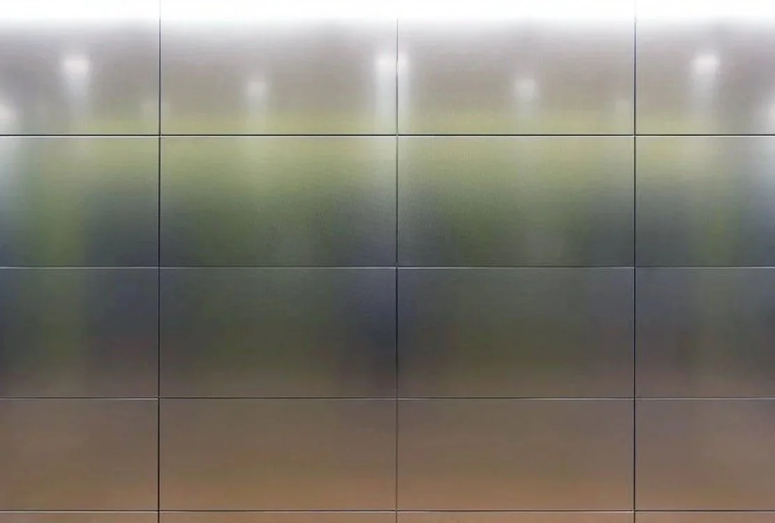 Reflective metallic panels on a wall or ceiling, creating a mirror-like surface.