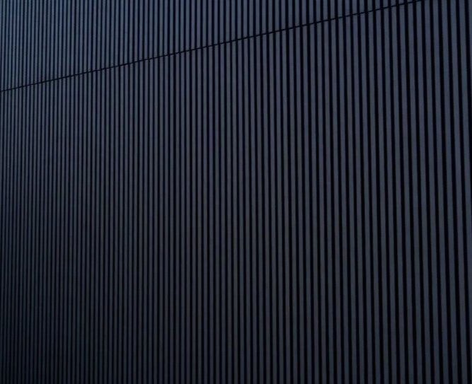 Close-up of a black corrugated metal wall.