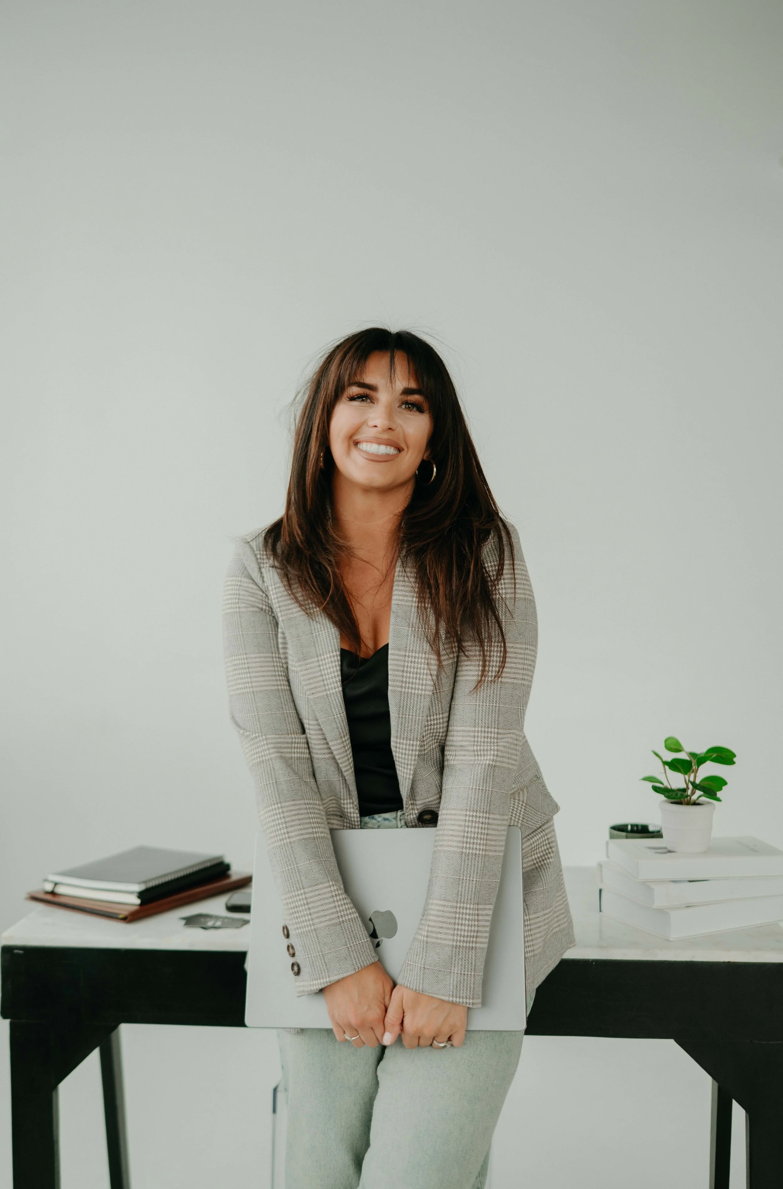 natalie jeffers leaning against desk