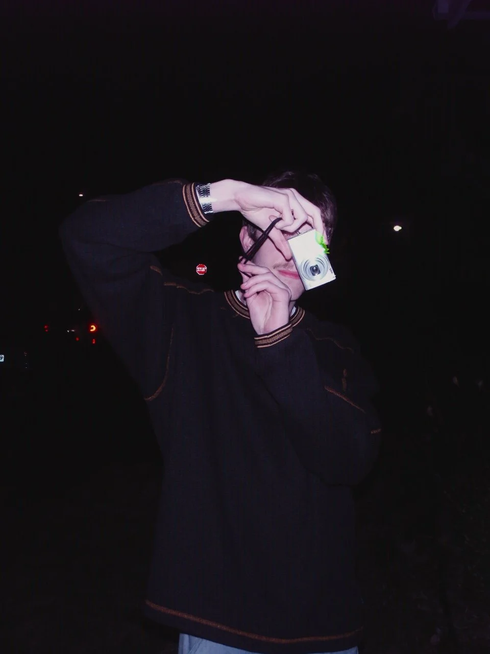 Photograph of me holding a digital camera.