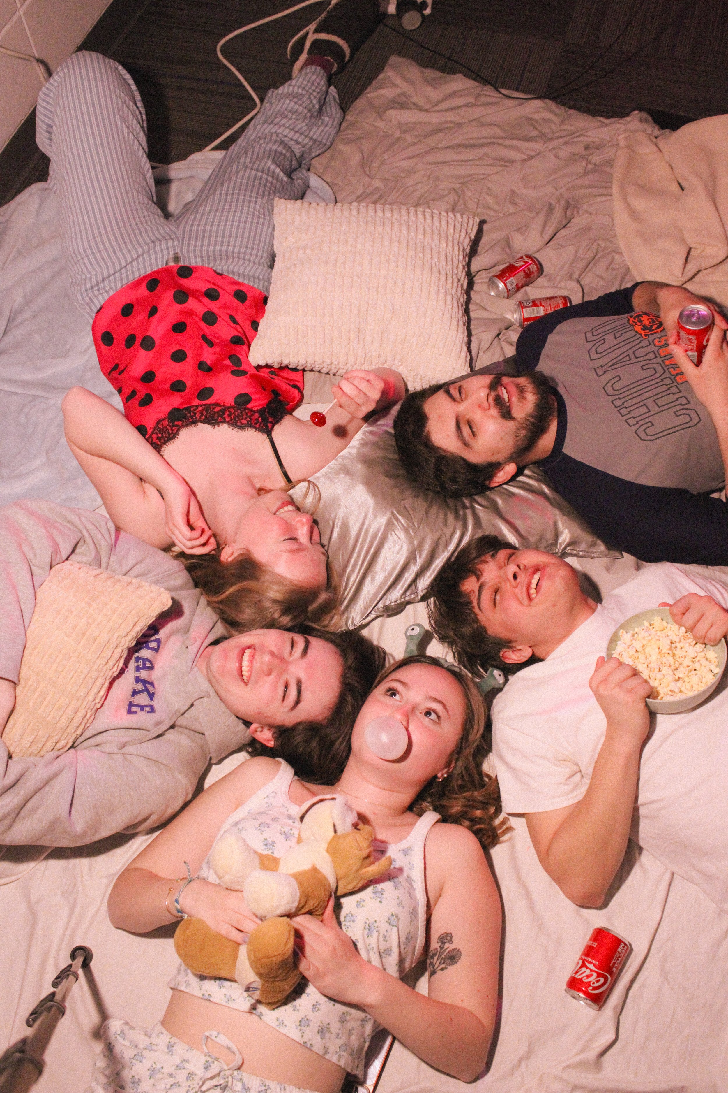 Comfort show photoshoot with members posed in pajamas.