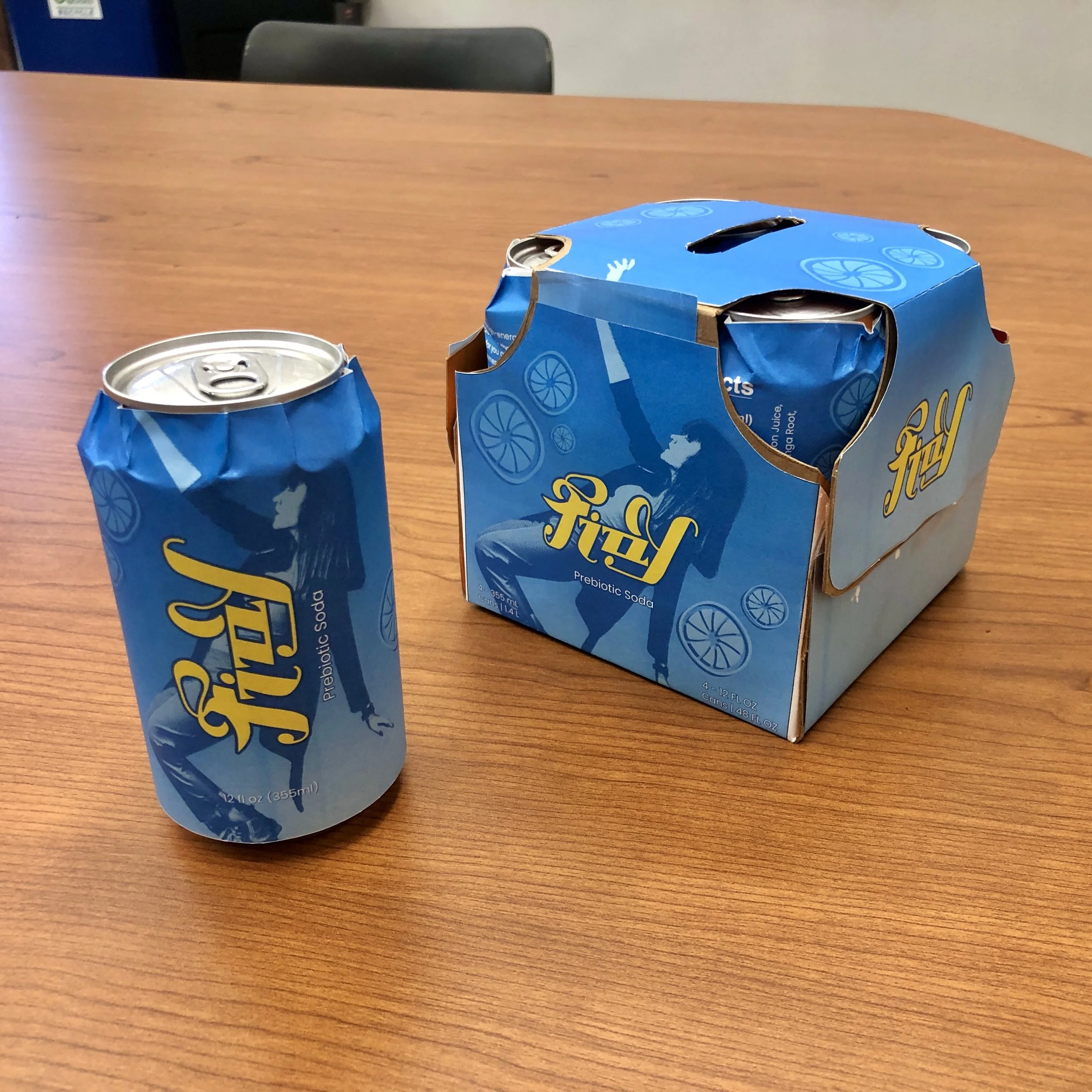 Photo of finished packaging mocked up fully. With designed can and pack.