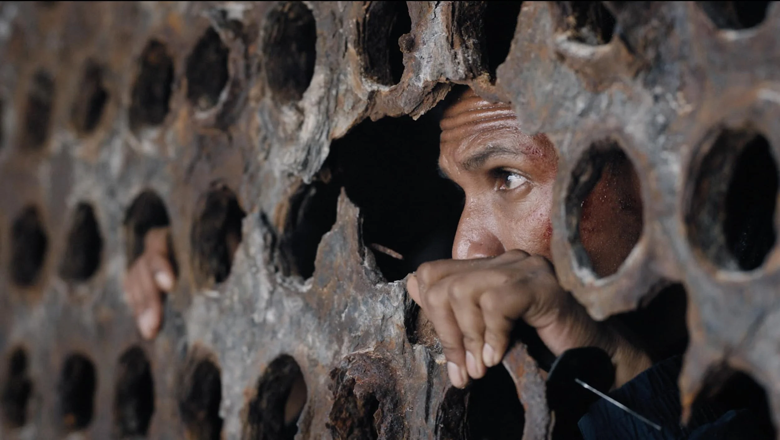Mikhail looking through hole_SOTS.jpeg