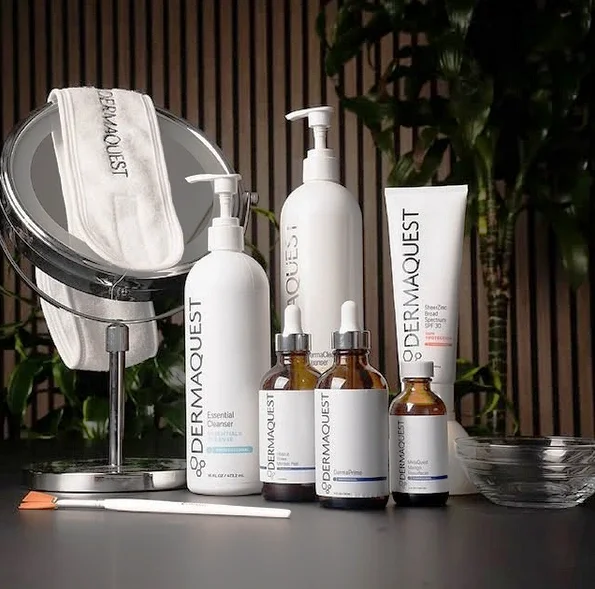 Medical-grade DermaQuest promotional photo of products used to create clearer skin giving dewy shining appearance, remove dead skin, and unclog pores.