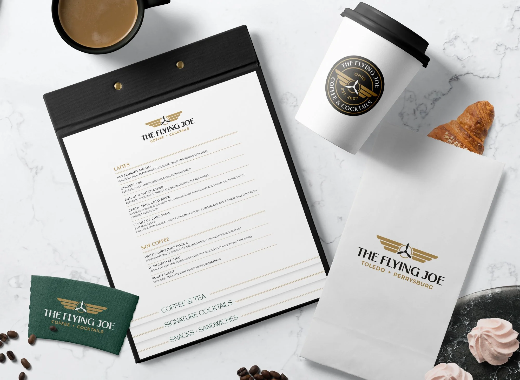 Photo of two wine bottles, a red and white, with custom illustrated labels in an art deco style .