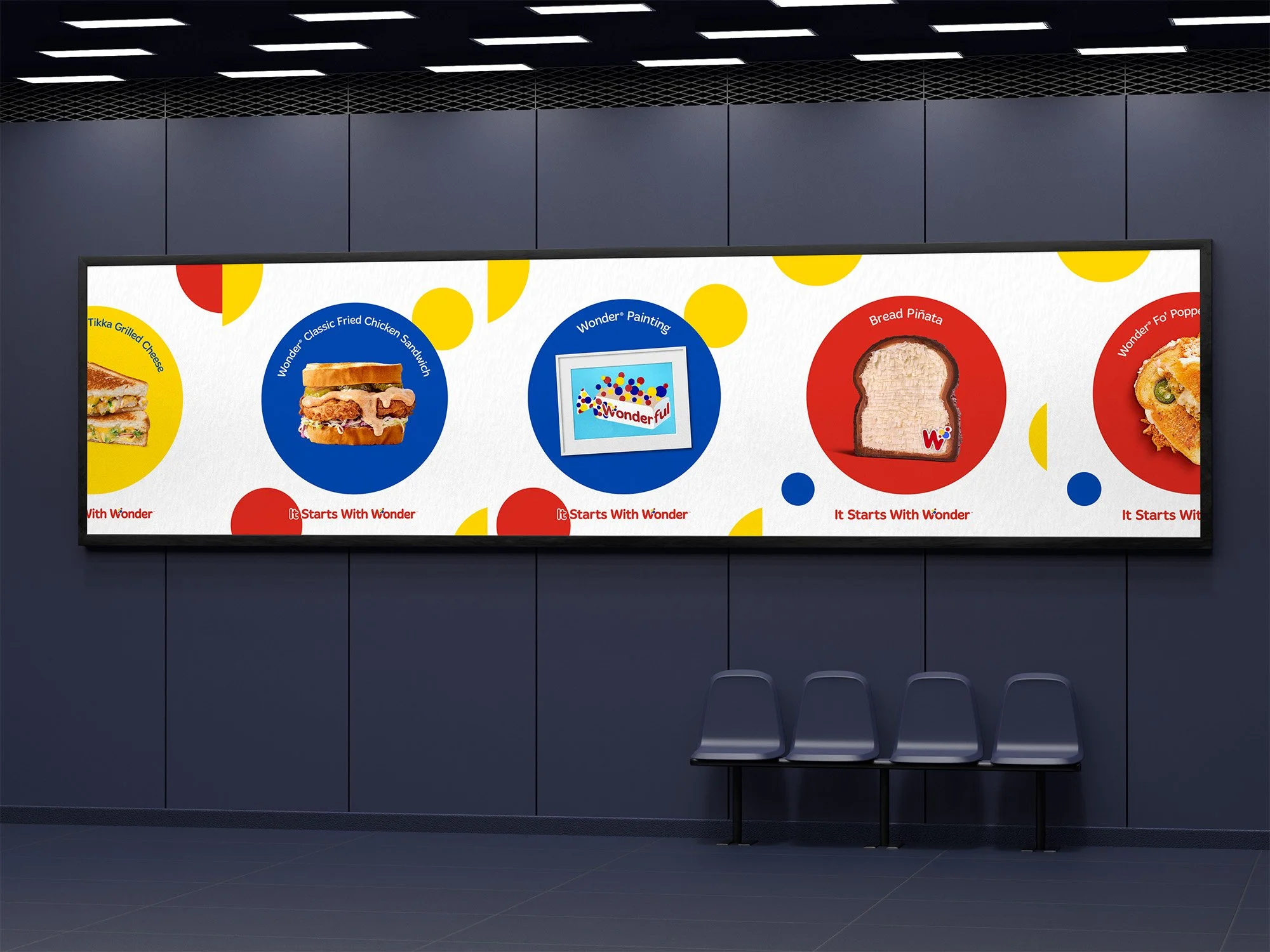 Digital menu board displaying various Wonder Bread items including grilled cheese, fried chicken sandwich, painting, bread piñata, and another food item with Wonder Bread branding, surrounded by colorful circles, in a modern waiting area with three c