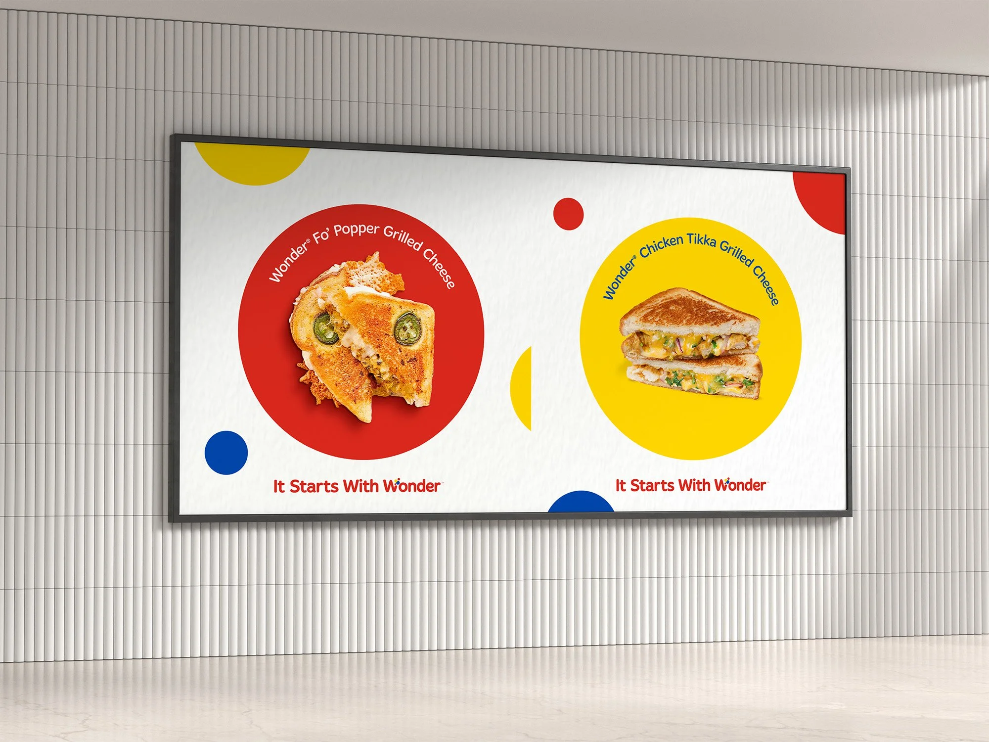 Digital advertisement showcasing two grilled cheese sandwiches. The left features a Wonder 'Fo' Popper Grilled Cheese in a red circle, with a crispy, melted sandwich with jalapeños, and the tagline 'It Starts With Wonder'. The right features a Wonder