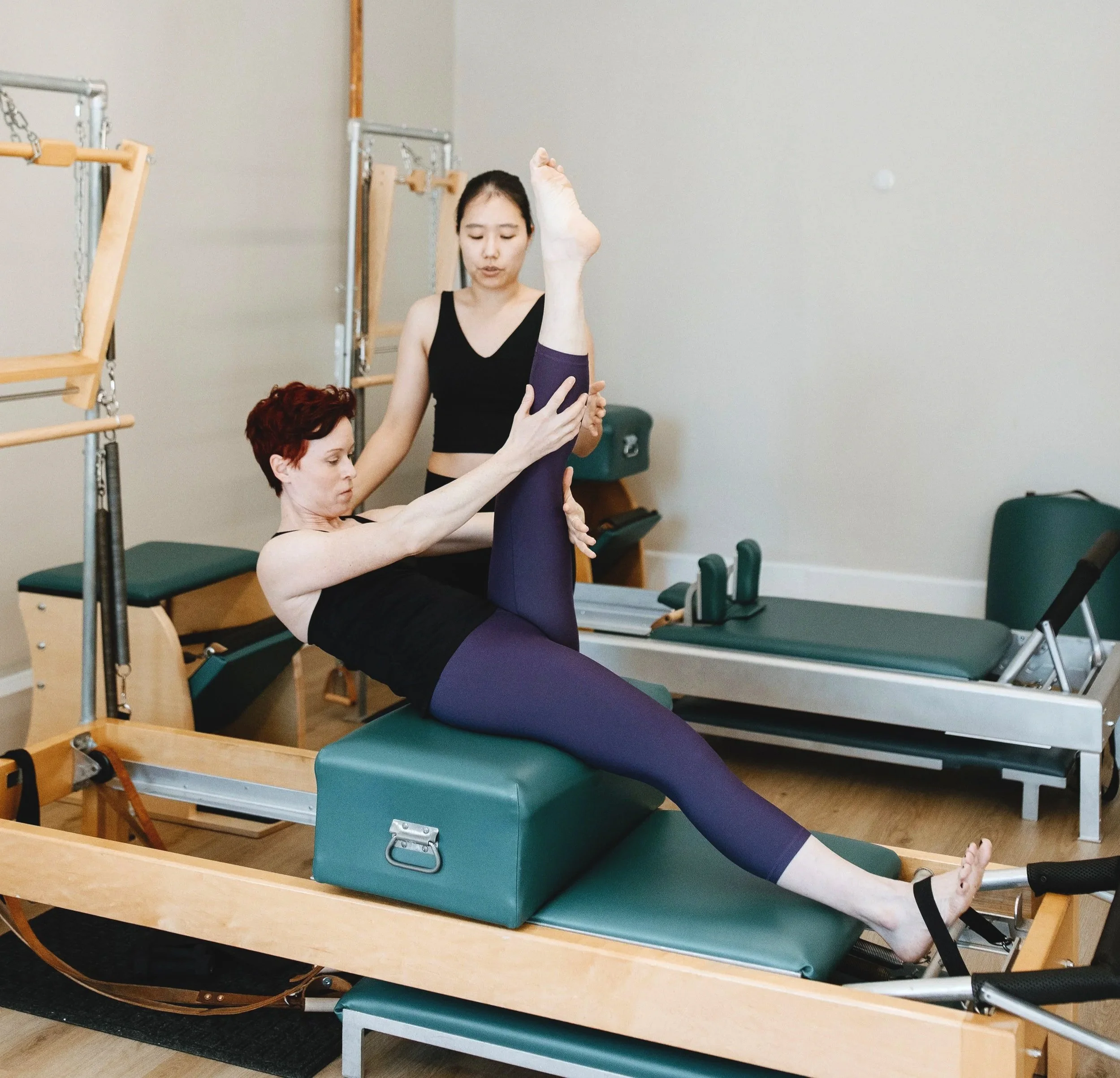 Pilates Instructor teaching a student in a private session