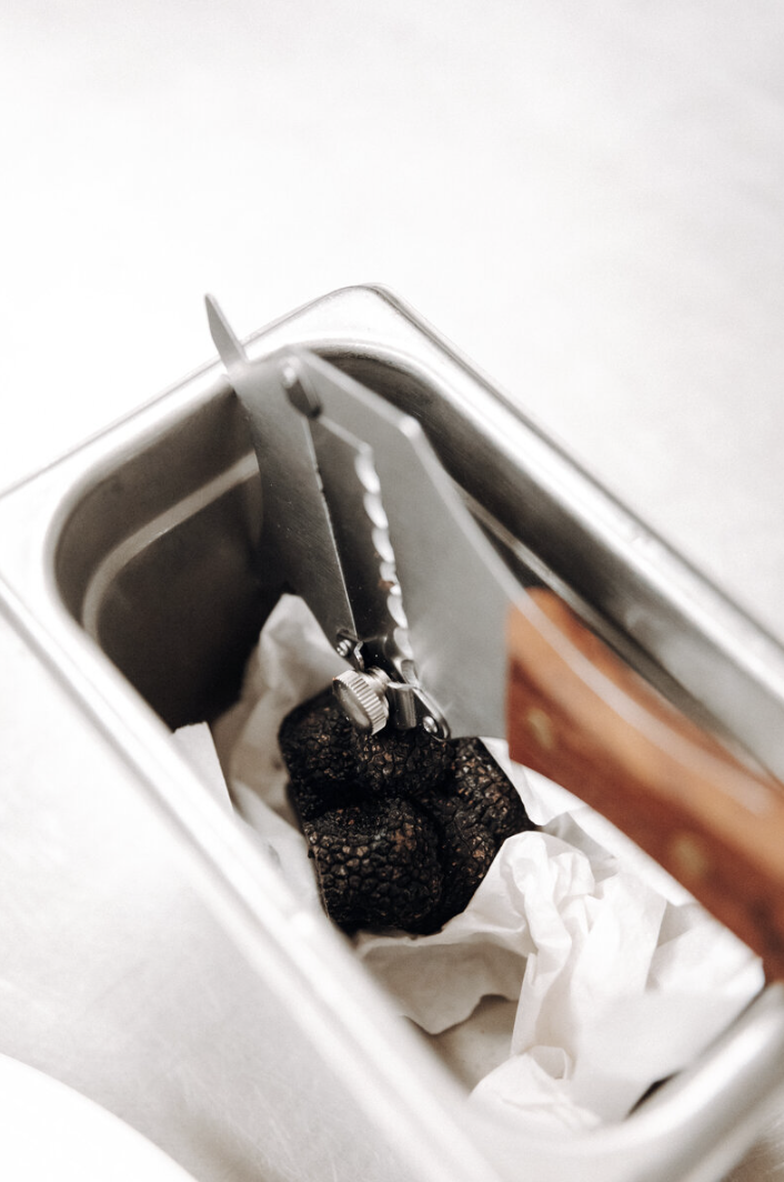 A close-up of a toaster with burnt toast inside, partially in a paper bag.