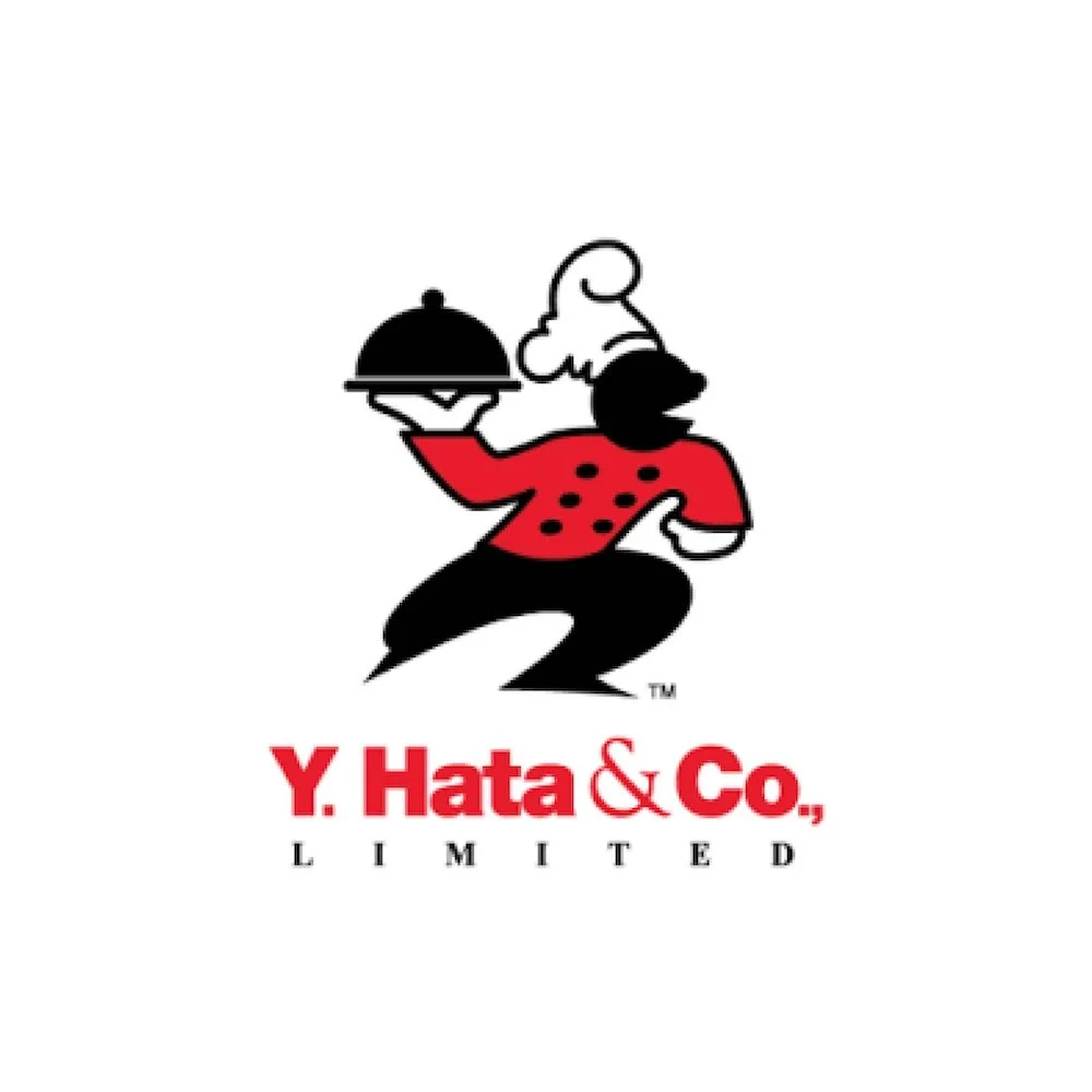A cartoon chef with a white hat, red shirt with black spots, and black pants, holding a serving tray with a cloche cover, along with the text "Y. Hata & Co., LIMITED" below.