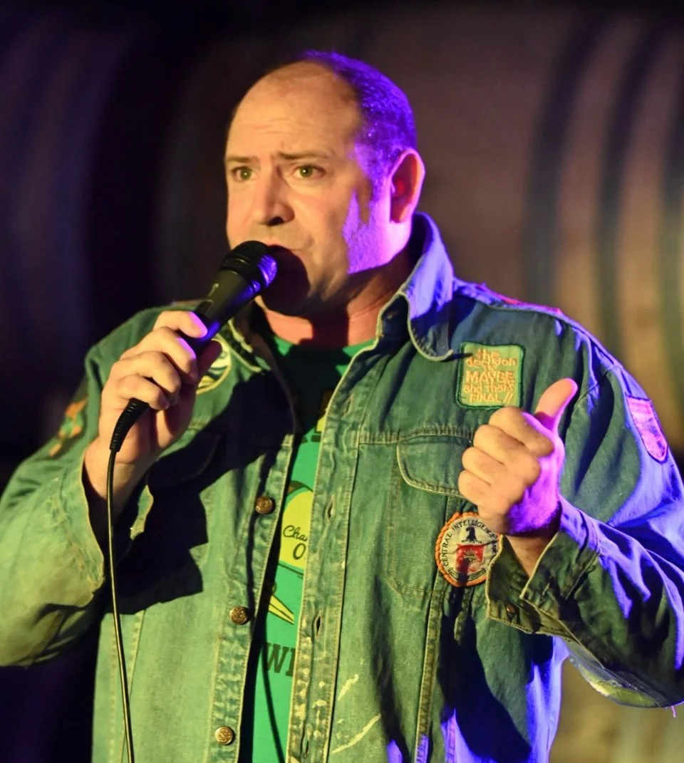 Stand-up comedian delivering laughs on stage at a packed Wine Country comedy night, hosted by LOL 707.