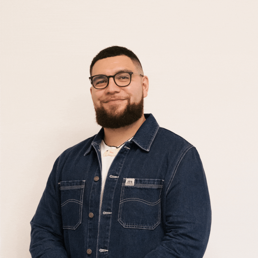 Three photos of Jacob McGregor (director of AWE), interchanging. He is alternating between smiling, looking in awe, and then doing a rock-star pose. All this takes place in front of a plain white background. 