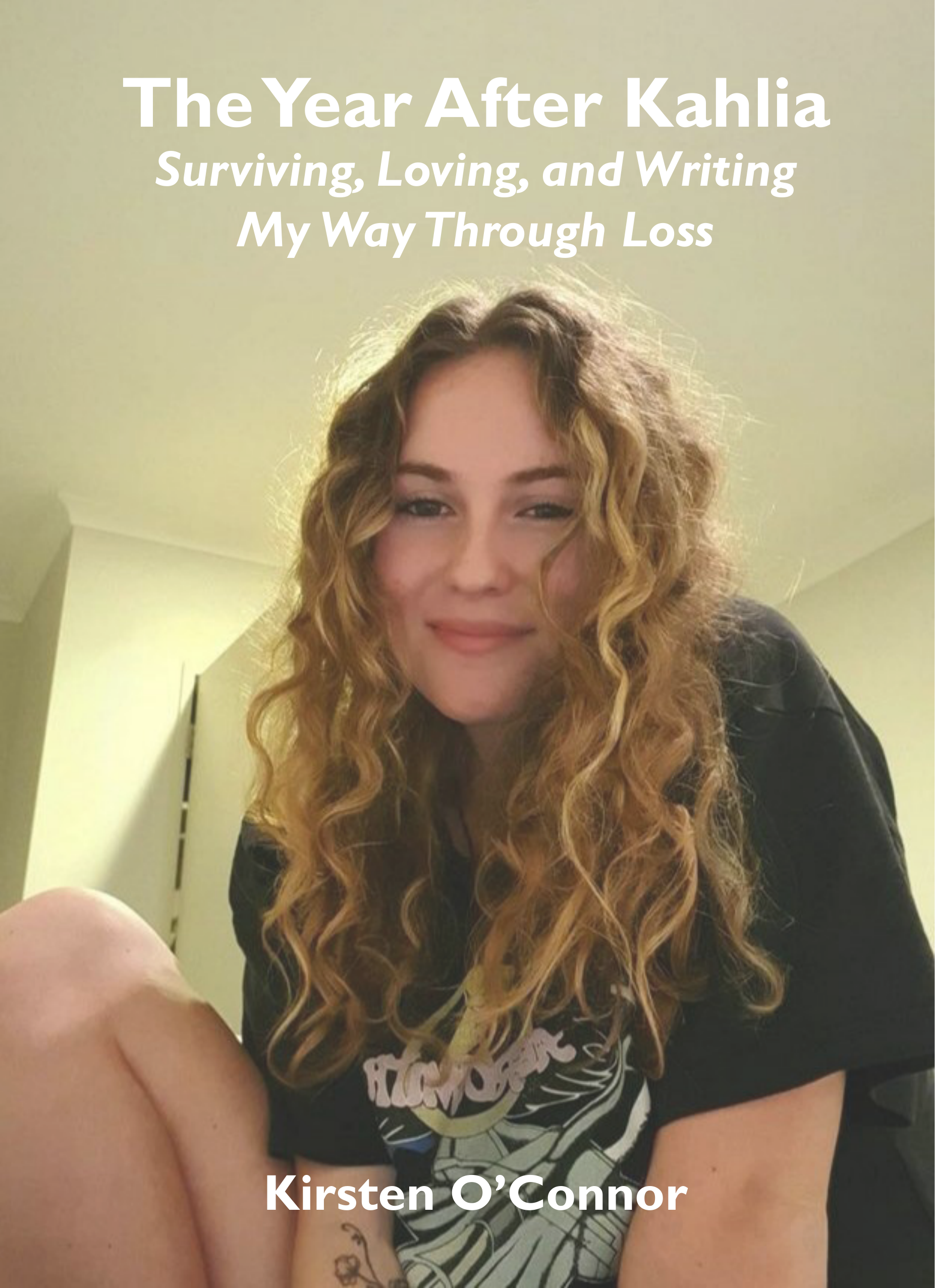 Scenic landscape with a large body of turquoise water, rolling green hills, and mountains in the background under an overcast sky.