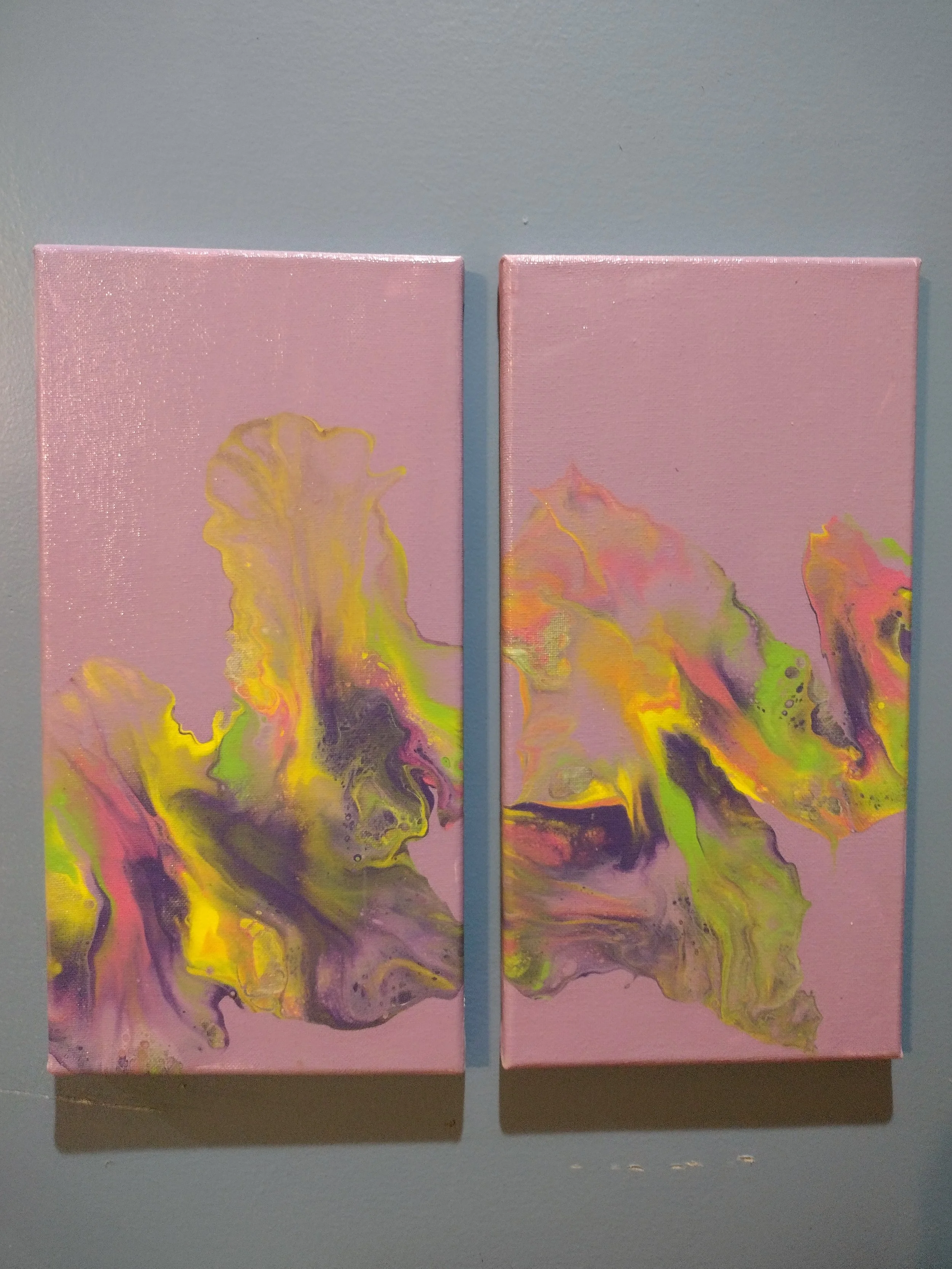 This original diptych was created using a Dutch pour technique that I have been developing and refining to create soft, flowing movement and delicate layers of color. Vibrant yellows, pinks, purples, and greens interact across two canvases, inviting 