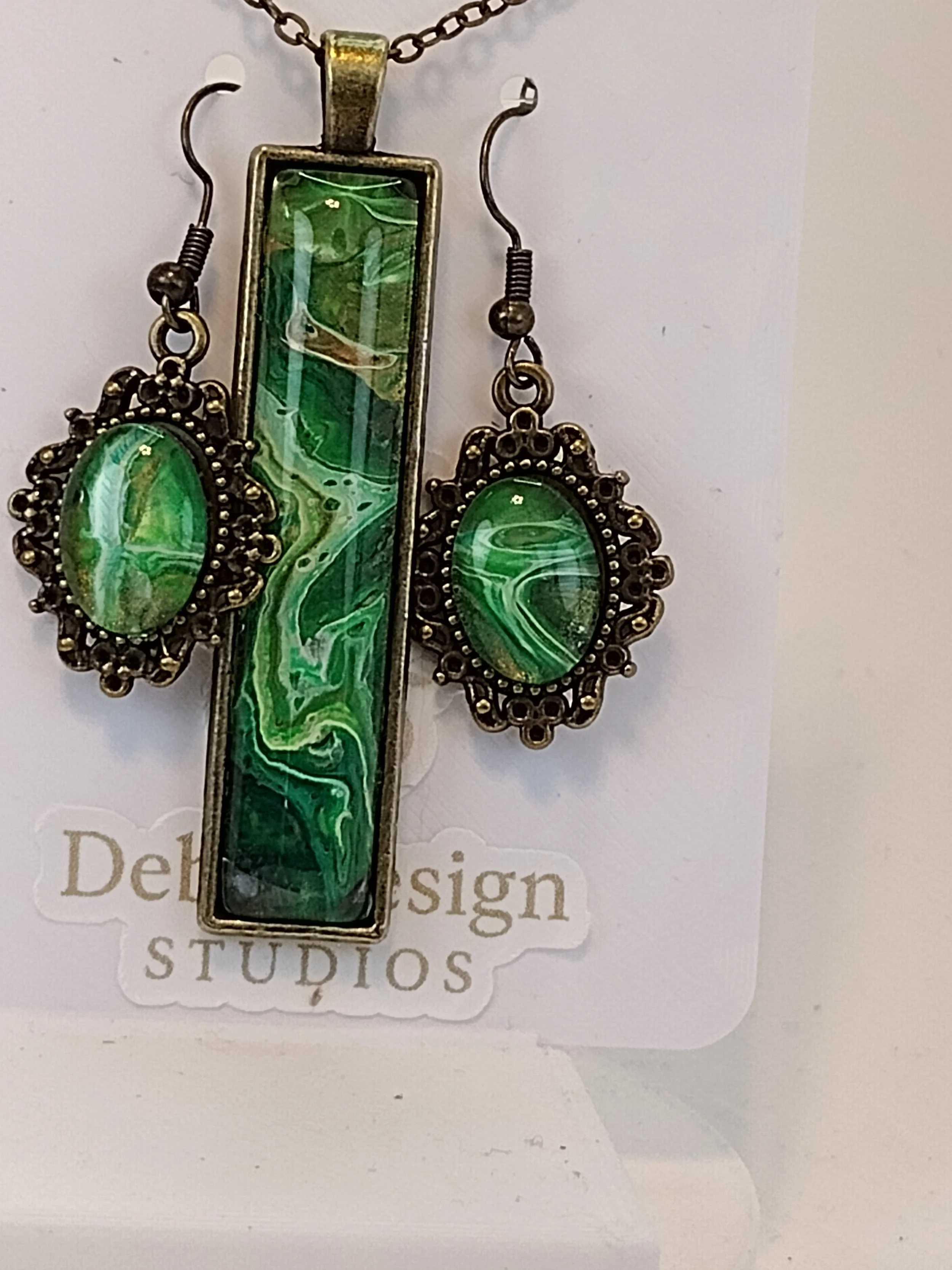 Each piece of jewelry begins as an unexpected work of art. During the paint-pouring process, the flowing acrylic paint naturally runs off the edges of the canvas and onto a silicone surface, where the colors blend together in unique and unpredictable