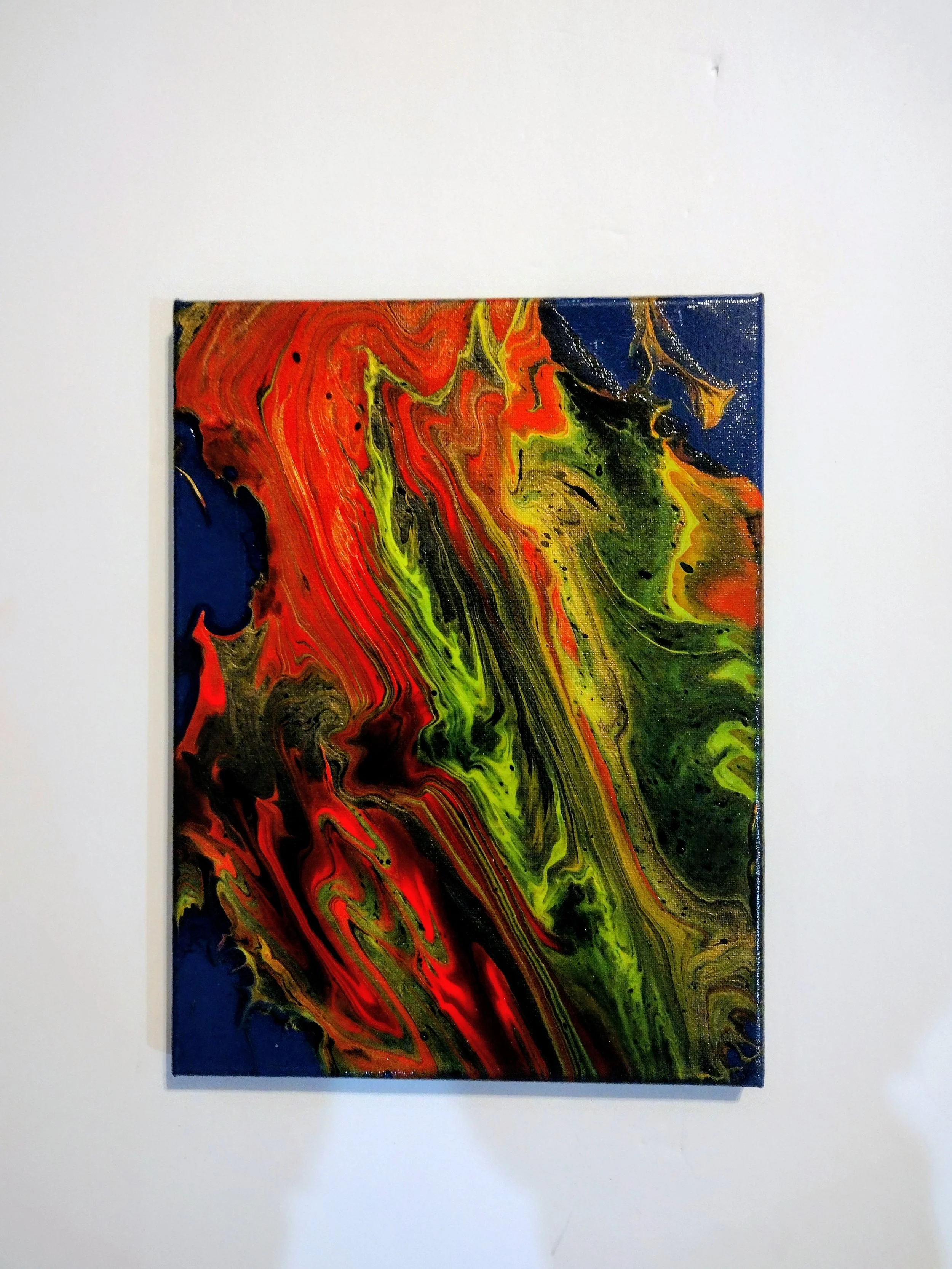 Inspired by the dancing flames of a campfire, this acrylic paint pour captures the warmth, movement, and energy of fire through flowing reds, oranges, golds, blacks, and vibrant greens. Created using a straight pour and stretched across the canvas, t