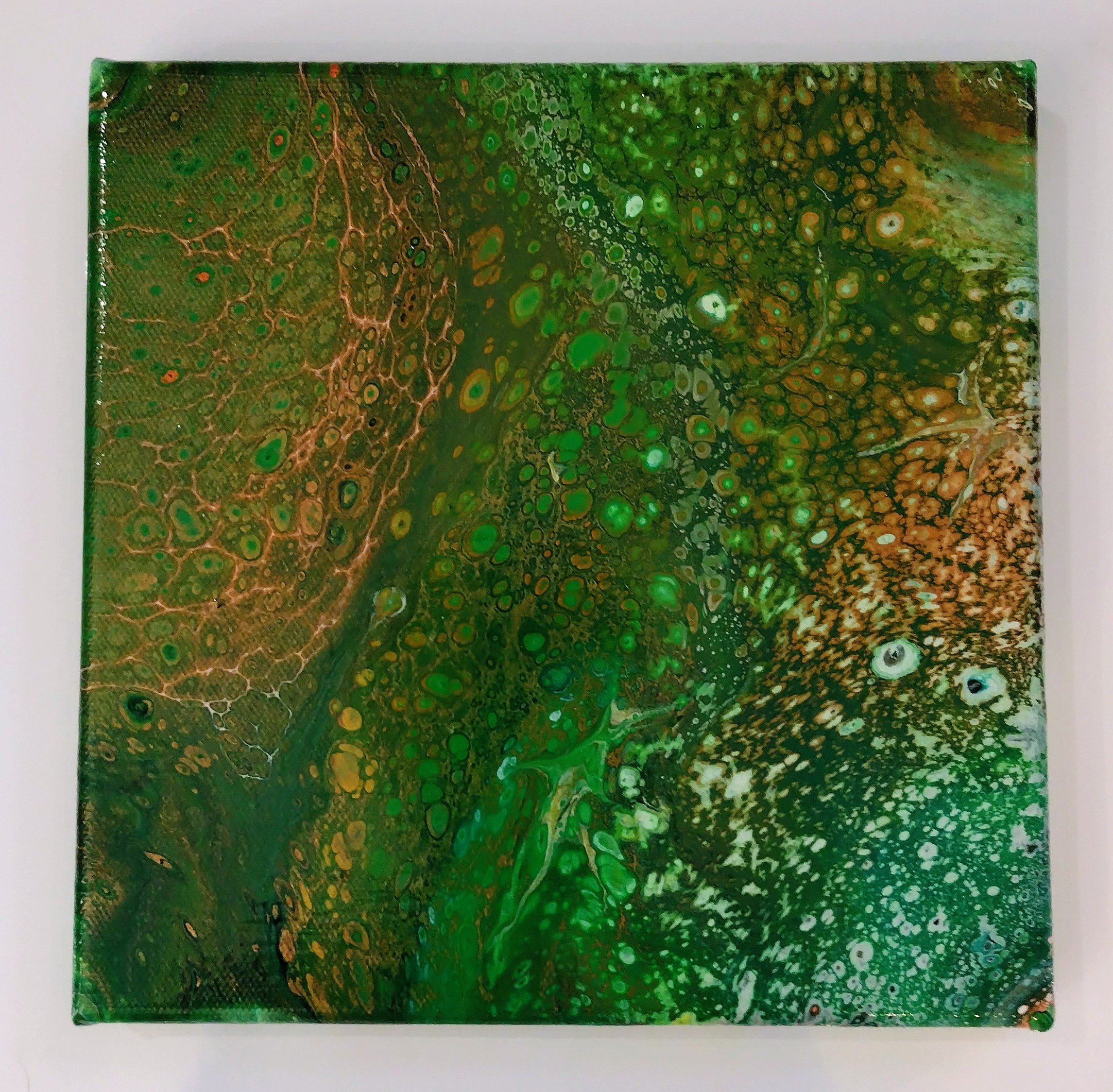 "Emerald Bloom" was created using a fluid acrylic pour technique that allows the colors to interact naturally, creating unexpected depth and texture. The golden undertones rise through the green like sunlight through a canopy, evoking forest moss, pr