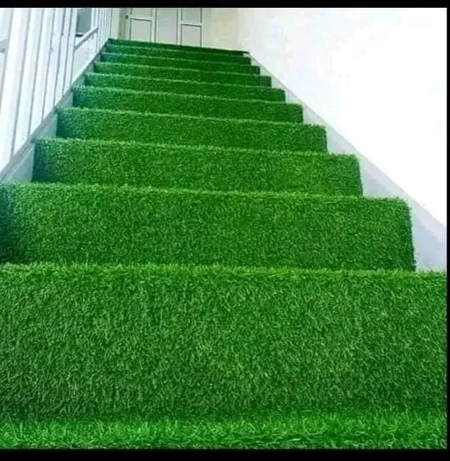 Indoor staircase covered with green artificial turf.