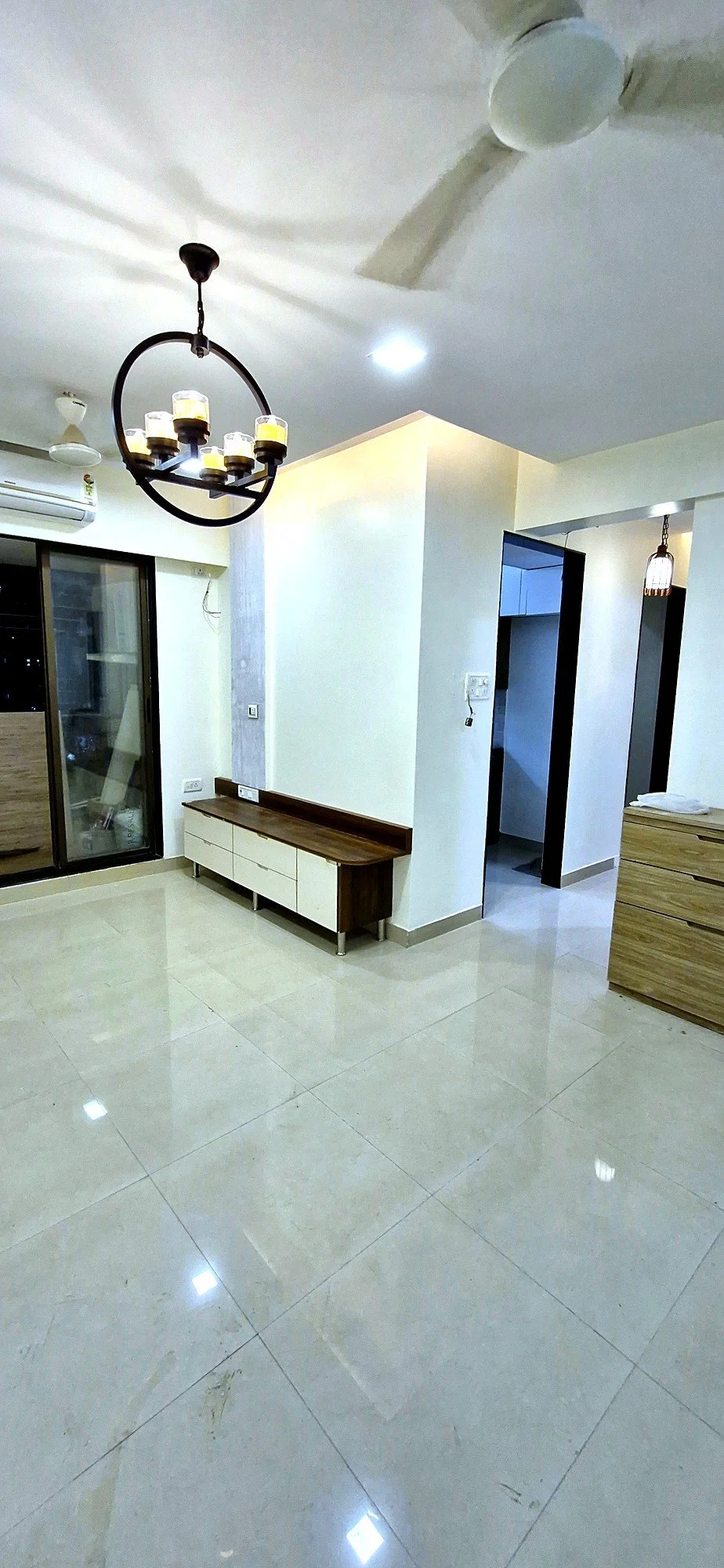 Living and passage area with white storage cabinetry at Lake Pleasant Powai 2BHK