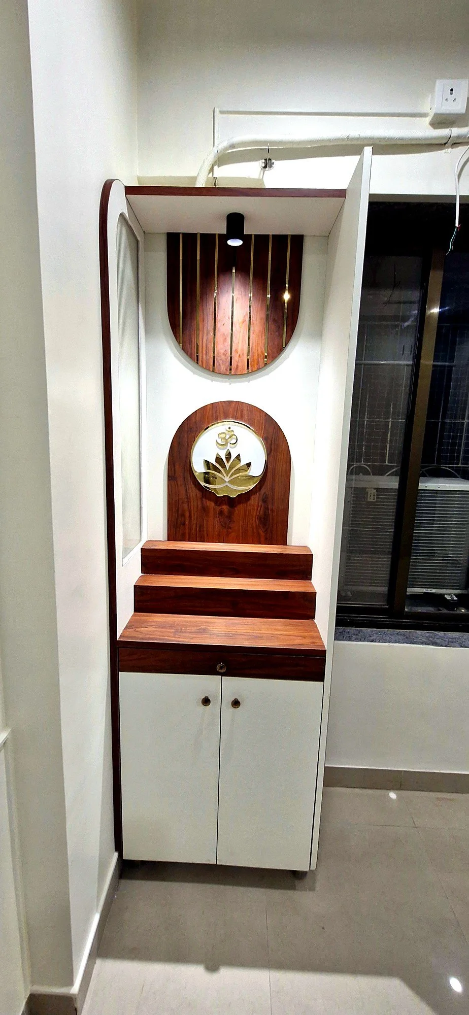 Custom pooja unit built into the foyer at Lake Pleasant Powai 2BHK