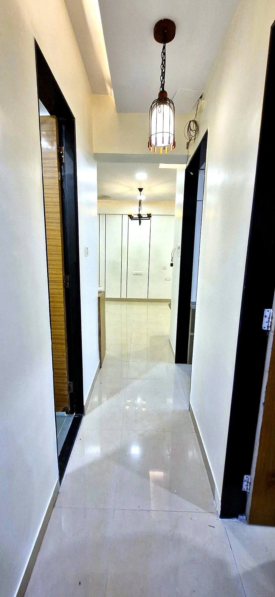 Renovated corridor with pendant lighting at Lake Pleasant Powai 2BHK