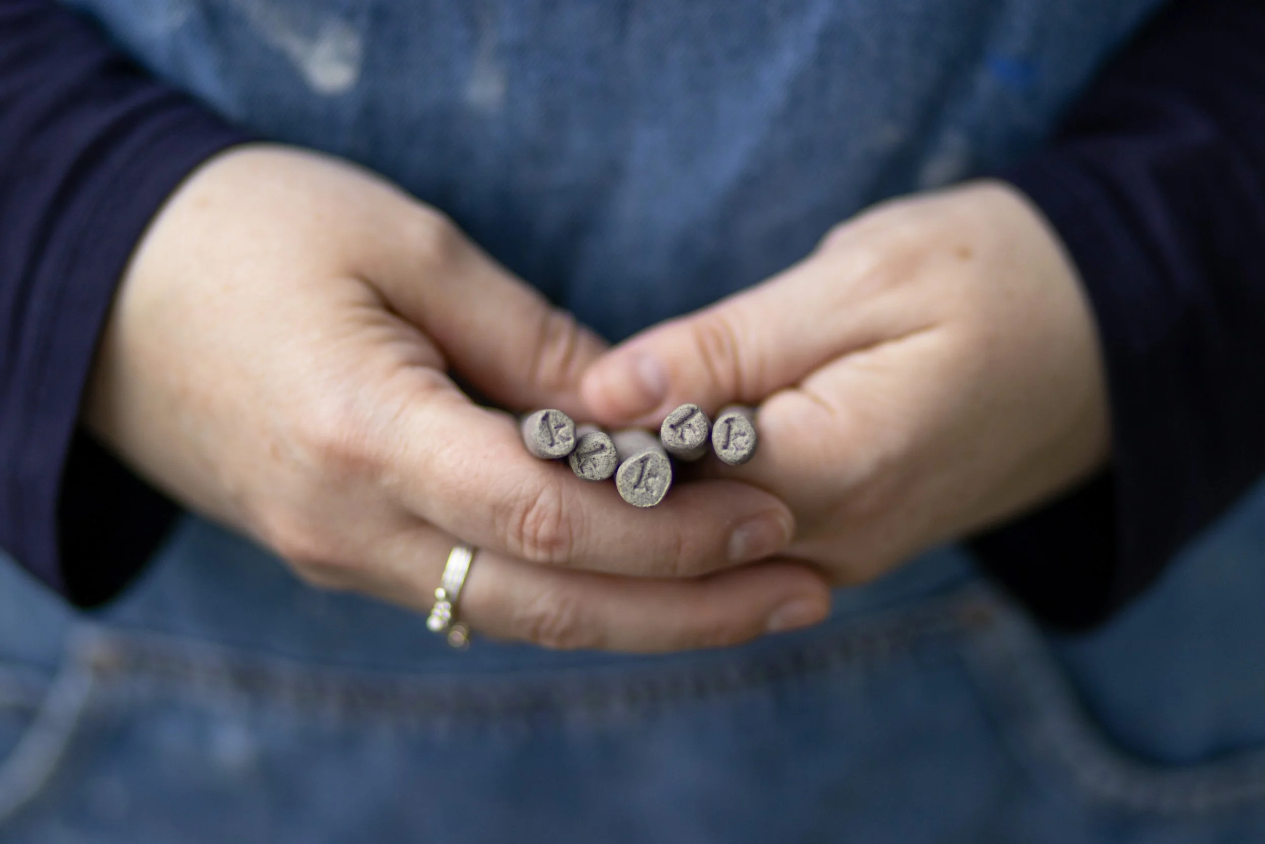K stamp at the end of the hand-shaped spoons