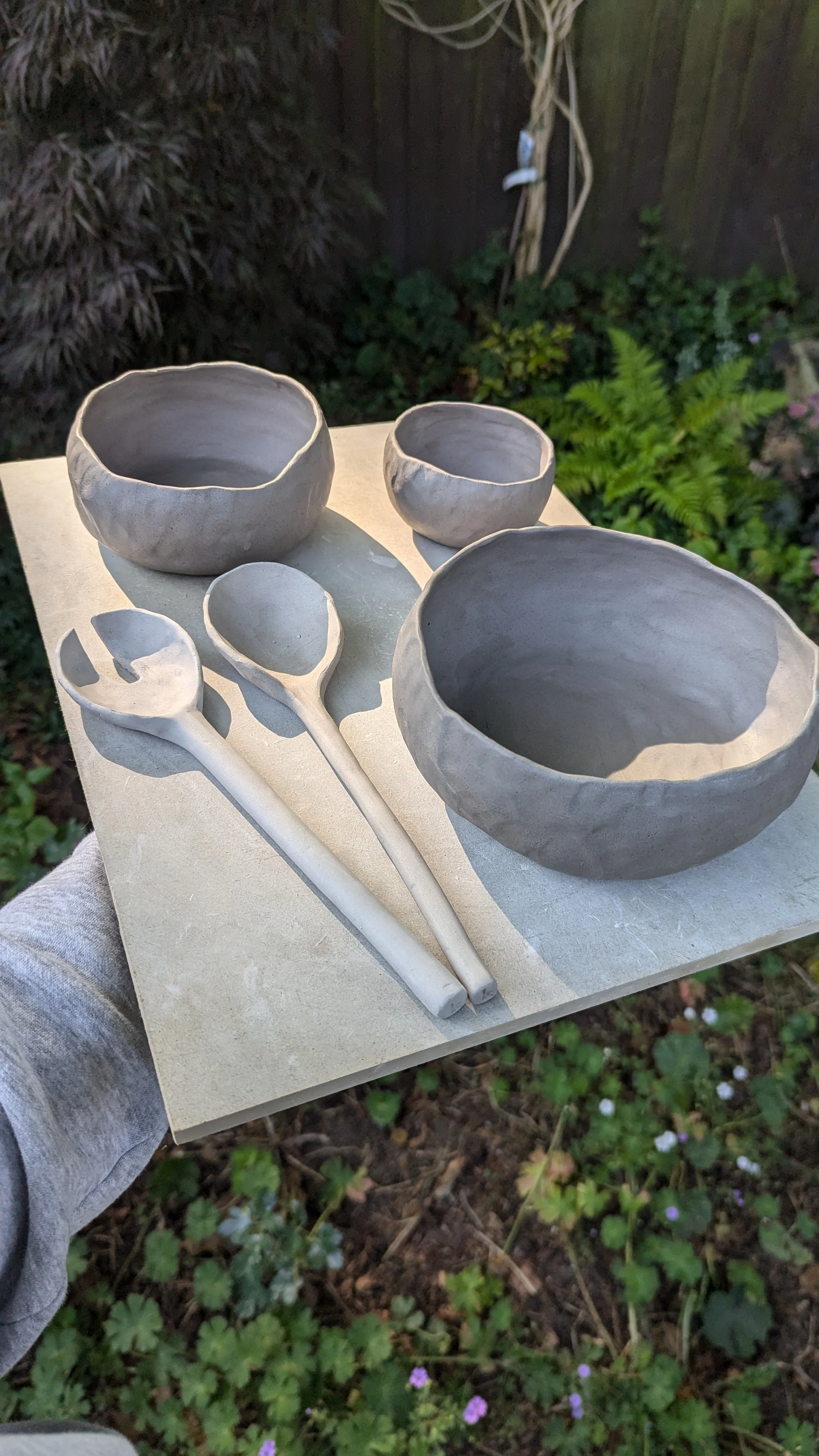 This is a shot of unfired work and Rachel Kay Ceramics carrying it from her studio to the kiln
