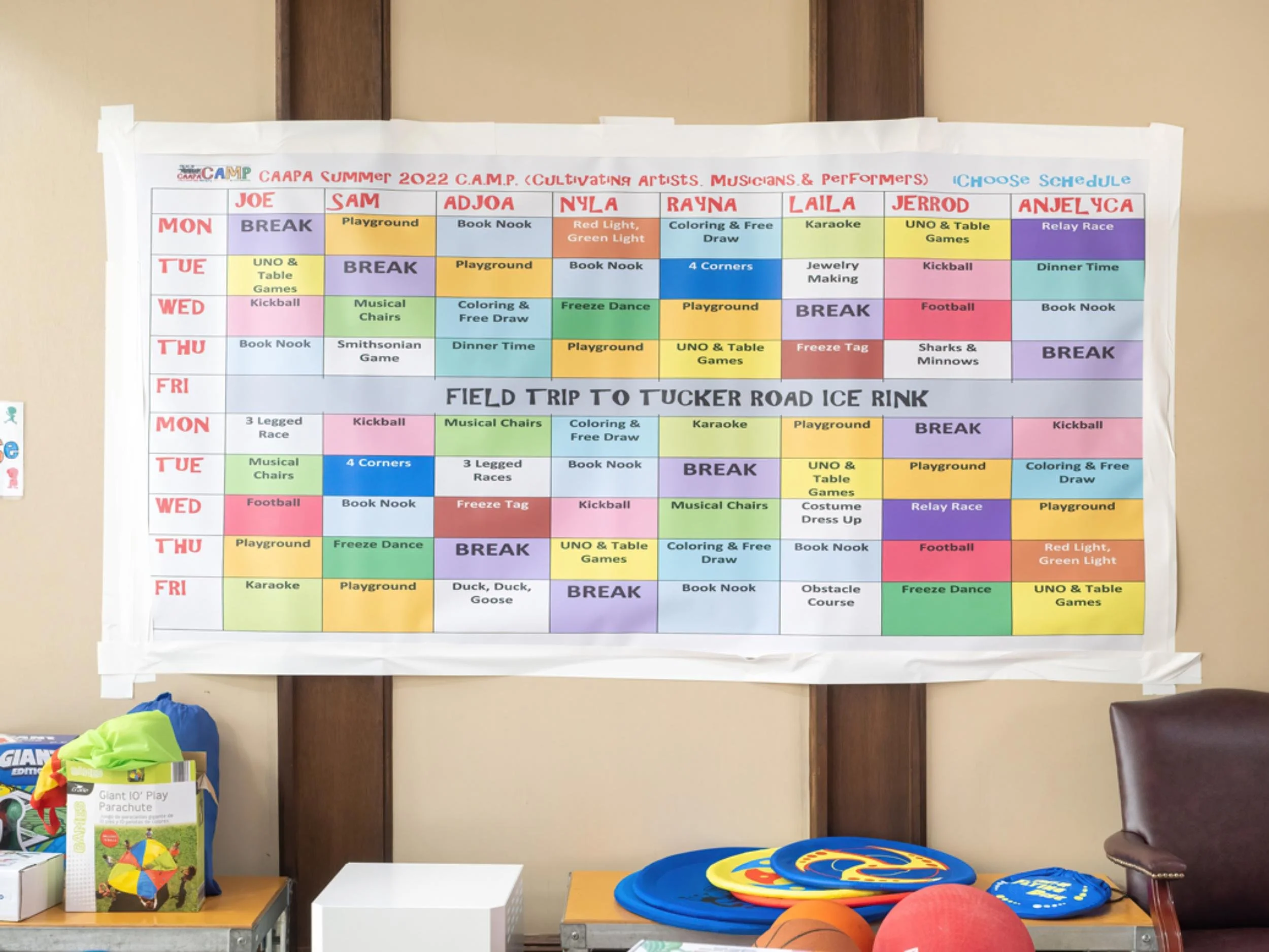 Weekly schedule chart for camp activities with days of the week listed and various activities in colored blocks, including sports, crafts, and games.
