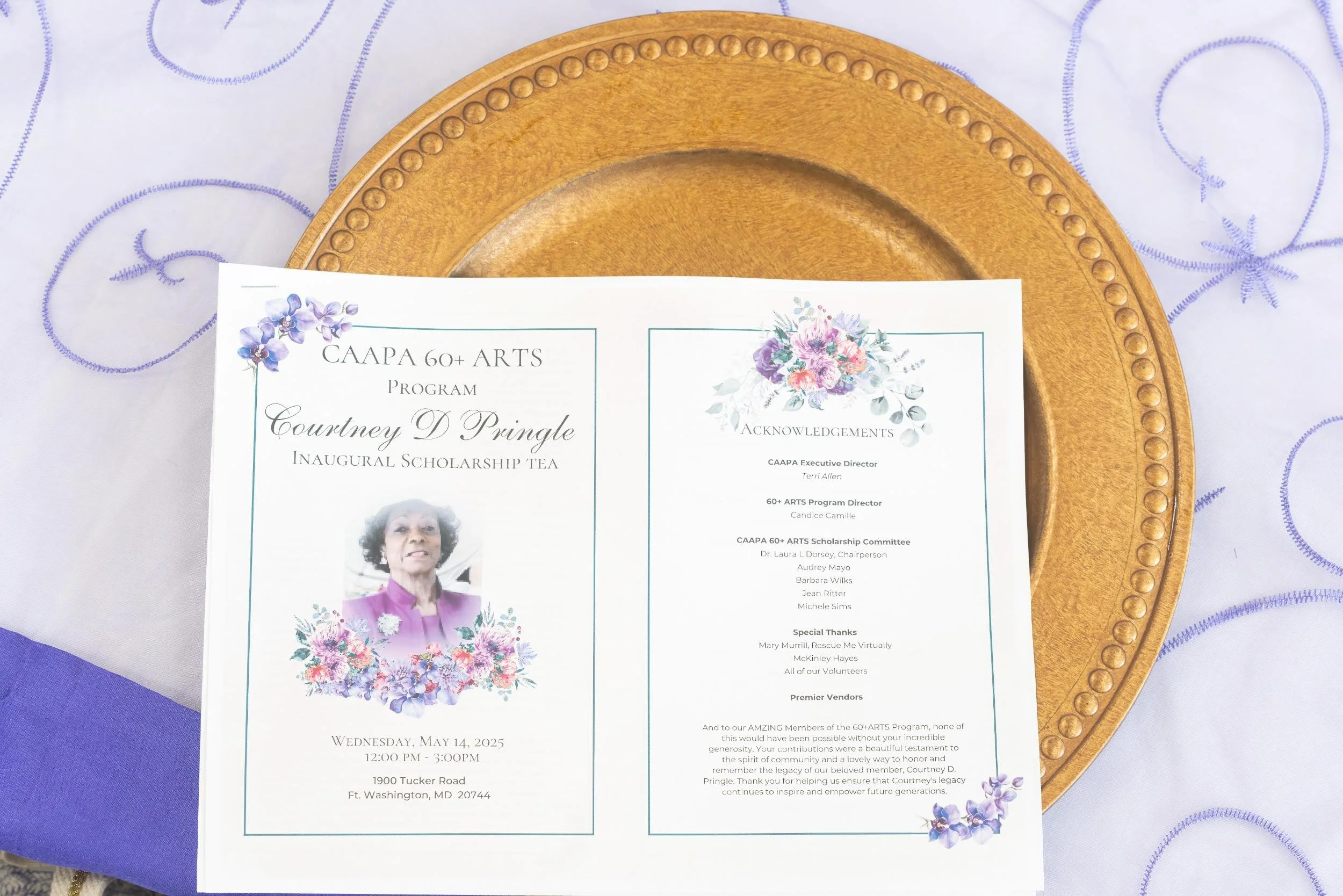 Program flyer for Cournty D Pringle's inaugural scholarship tea, featuring a photo of her, floral decorations, and event details.