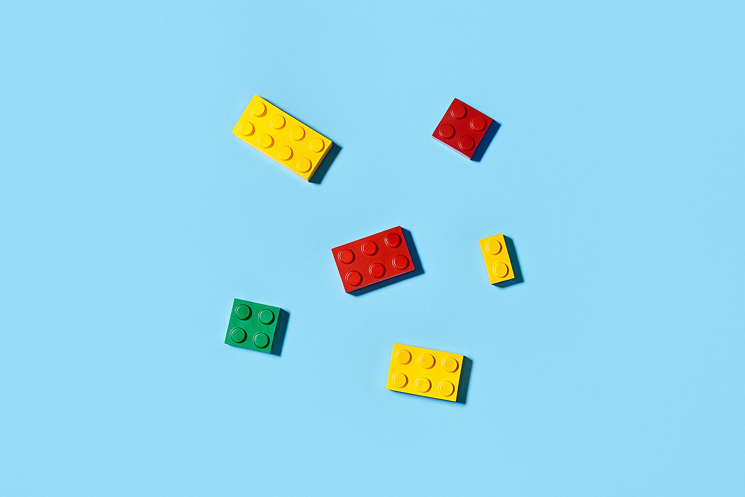Colorful toy building blocks on a light blue background