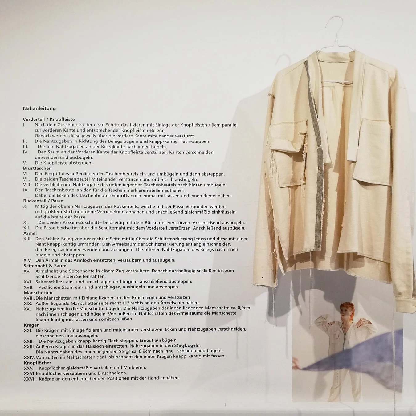 Komposition von Ausstellungsstücken an weißer wand: Kleidungsstück, Text, Bild von raum6.7
