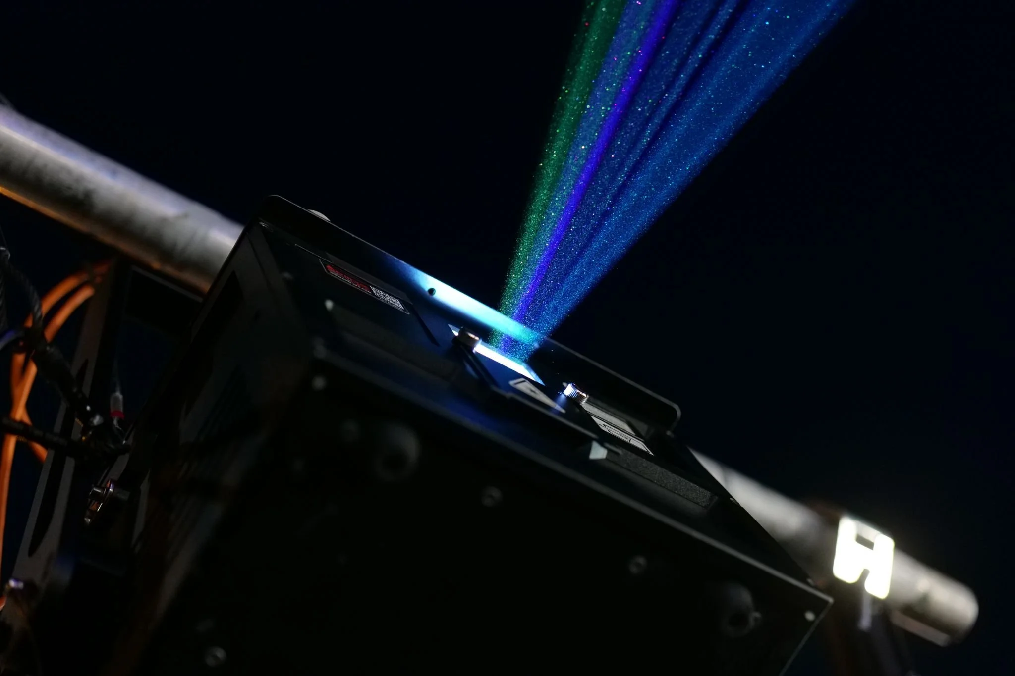 A computer graphics card with rainbow-colored light emission against a dark background.