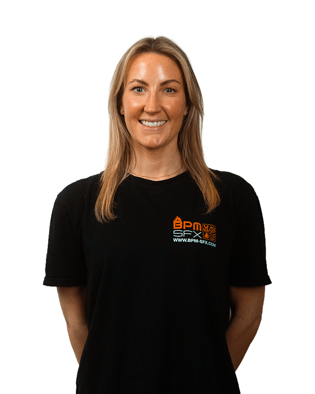 A woman smiling, wearing a black T-shirt with orange and white logo and website URL, standing against a light background.