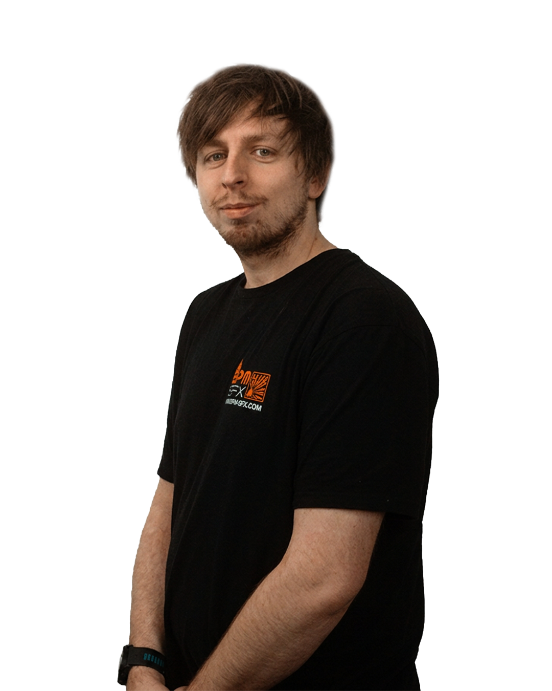 A young man with brown hair wearing a black T-shirt and a wristwatch, standing with his arms crossed in front of a white background.