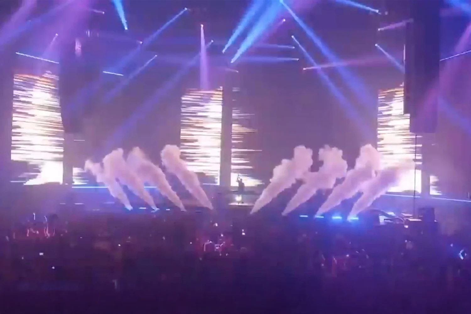 A stage with colorful lights and smoke effects during a concert or performance.