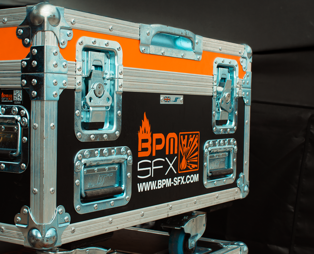 A black equipment case with orange and silver accents, metal handles, and reinforced corners, displaying a logo for BPM SFX and a website URL.