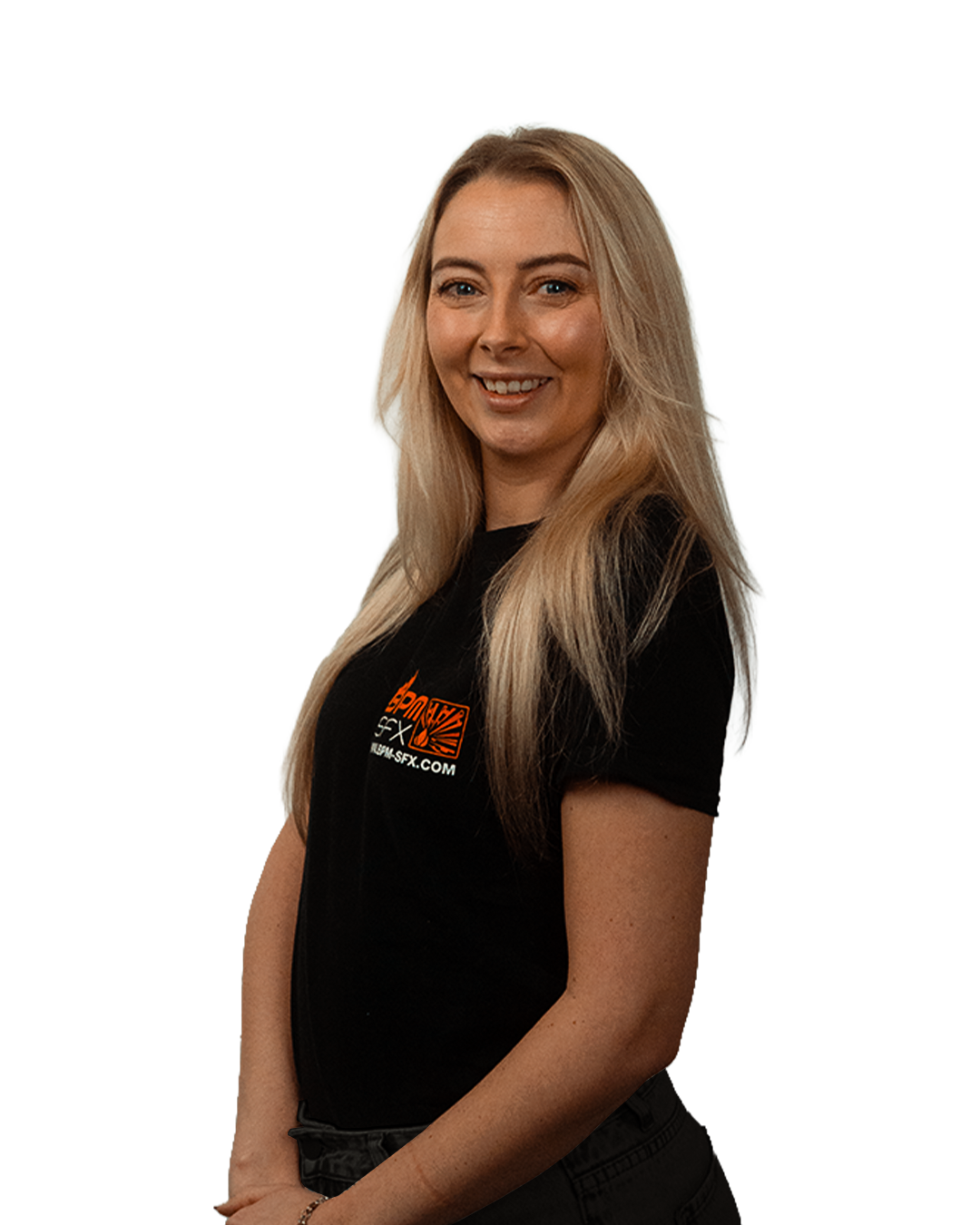 A woman with long blonde hair smiling and wearing a black t-shirt with orange and white logo and text, standing against a plain background.