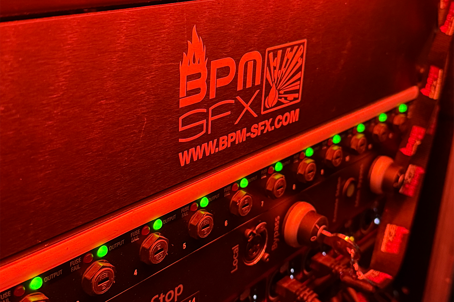 Close-up photo of an audio equipment panel with labeled switches and green indicator lights, featuring the logo and website of BPM SFX.