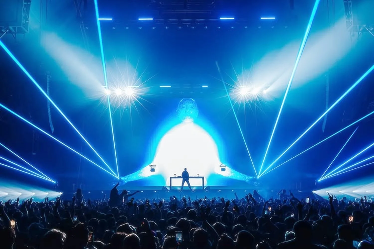 A DJ performance at a concert with blue laser lights and a crowd of people.