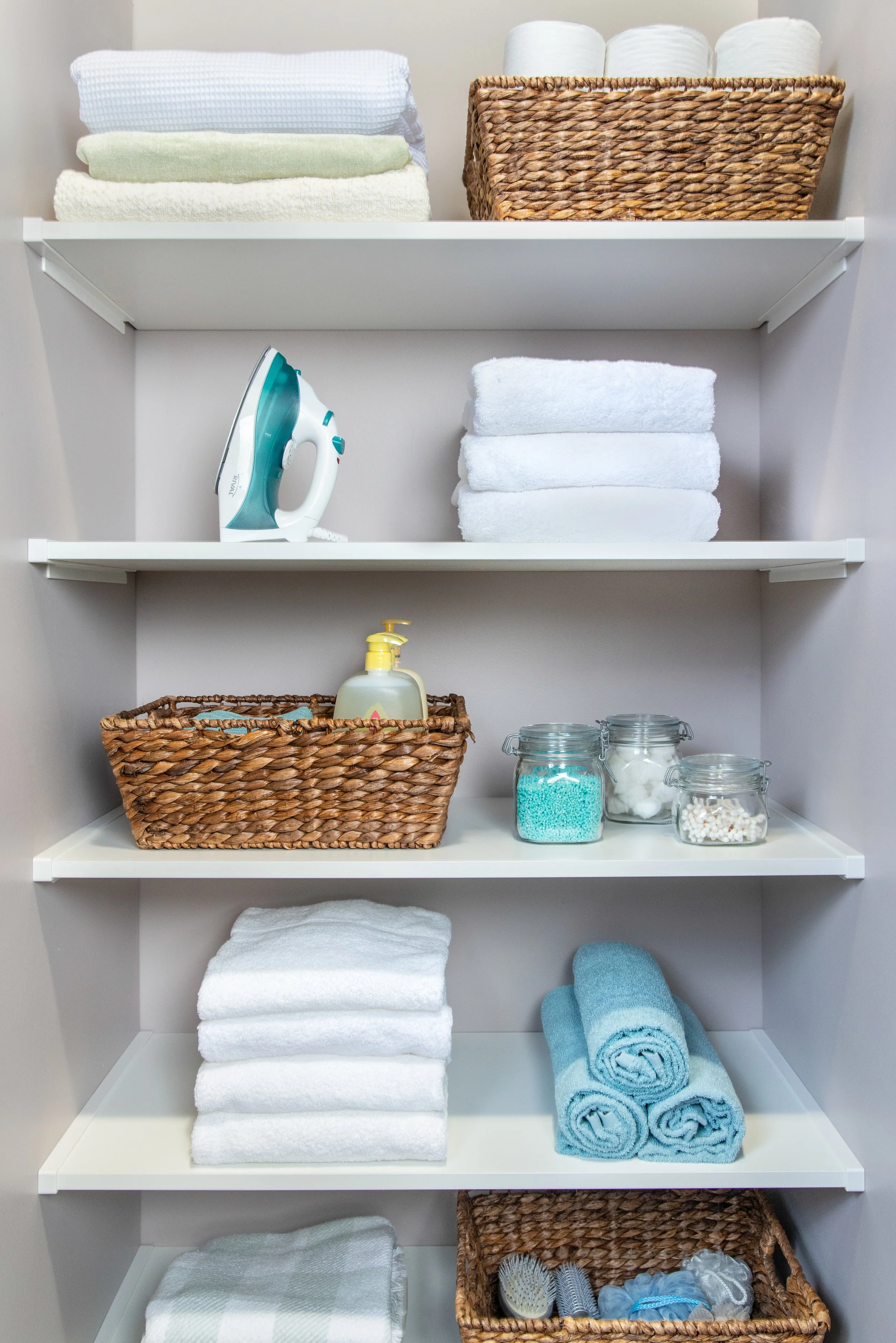 Linen closet with white shelves