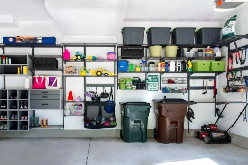 Organized garage with adjustable shelves, drawers, and cubbies holding storage bins, tools, sports equipment, and gardening supplies — a place for everything