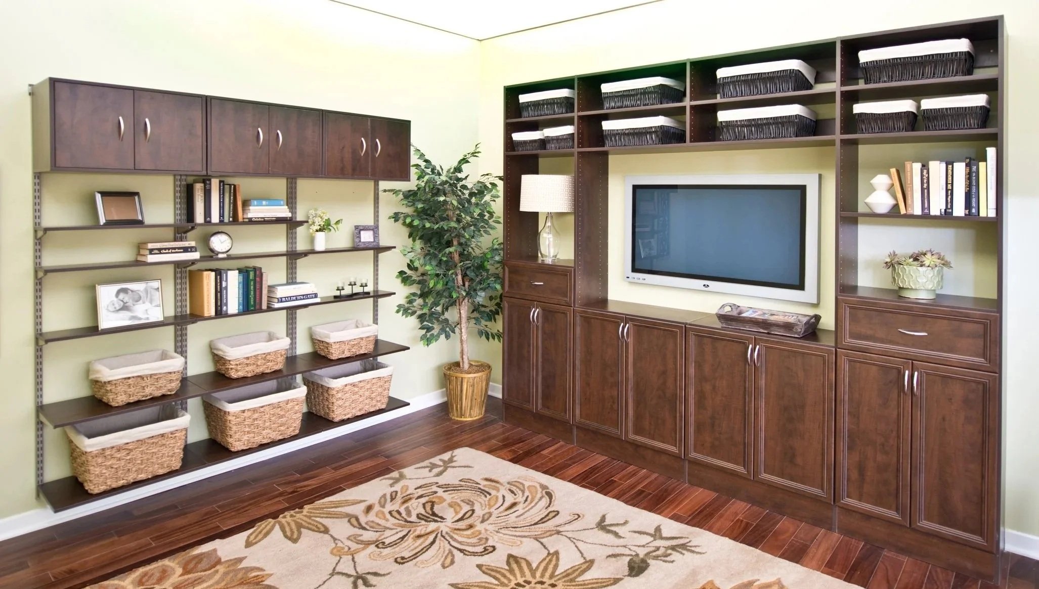 Organized family room featuring a custom entertainment center and matching storage area with adjustable cabinets and shelves filled with books, storage baskets, and decorative items