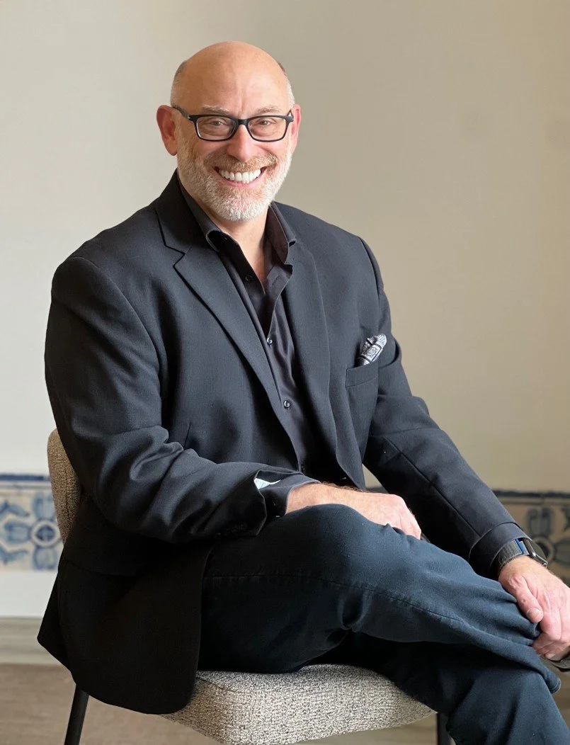 Mike Sigal, founder coach and venture advisor, seated and smiling.