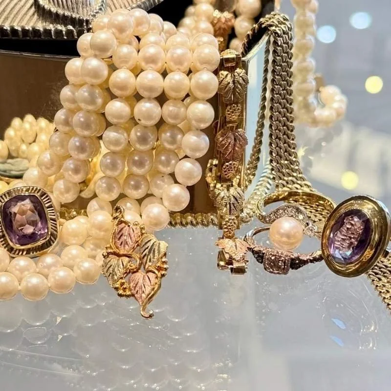 Estate jewelry collection featuring pearl necklaces, ornate gold jewelry and vintage-style gemstone rings at Shipley's Fine Jewelry in Fleming Island, FL