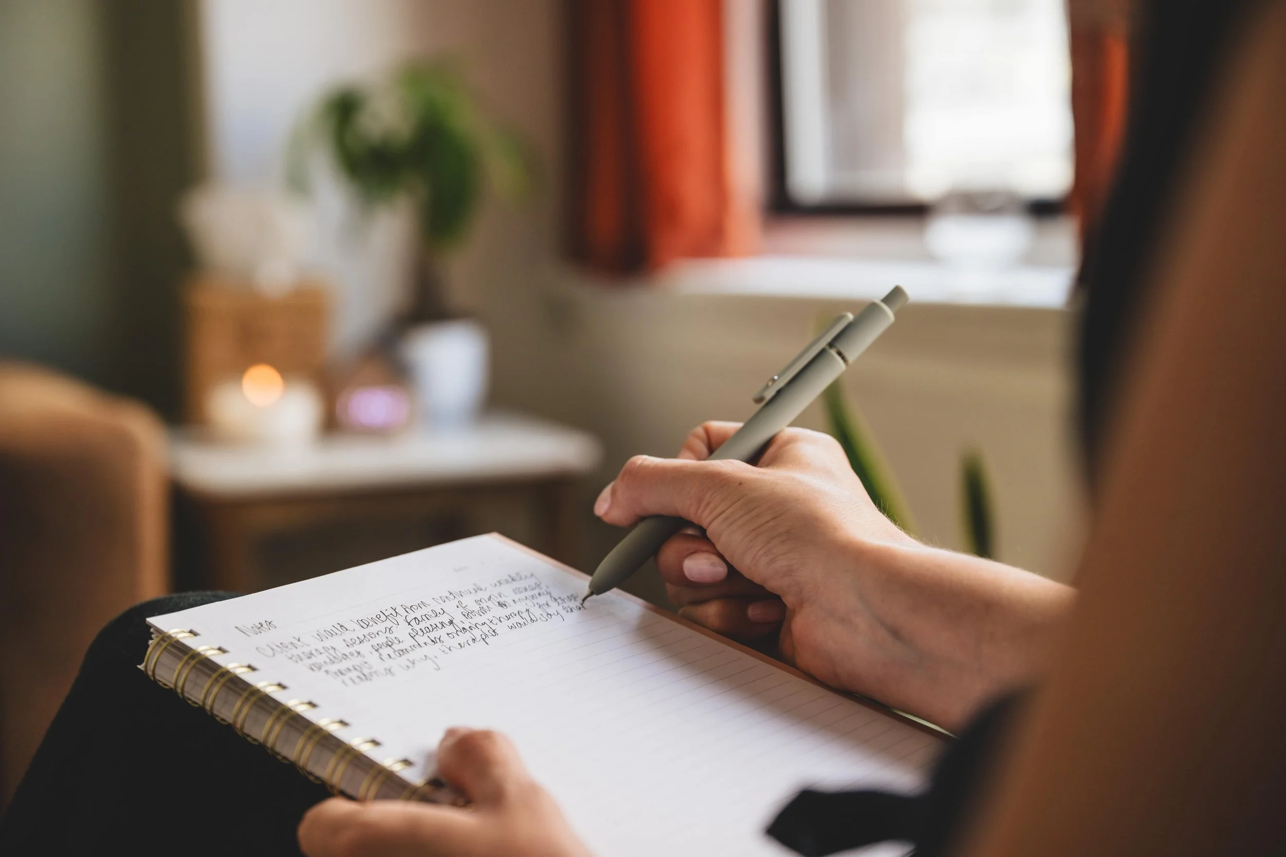 Therapist writing notes in book at Havn Therapy in Philadelphia
