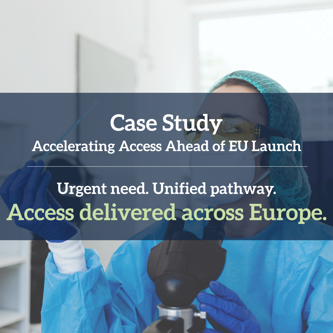 A researcher in protective gear, including a face mask, gloves, glasses, and a hair net, examining a slide under a microscope in a laboratory.