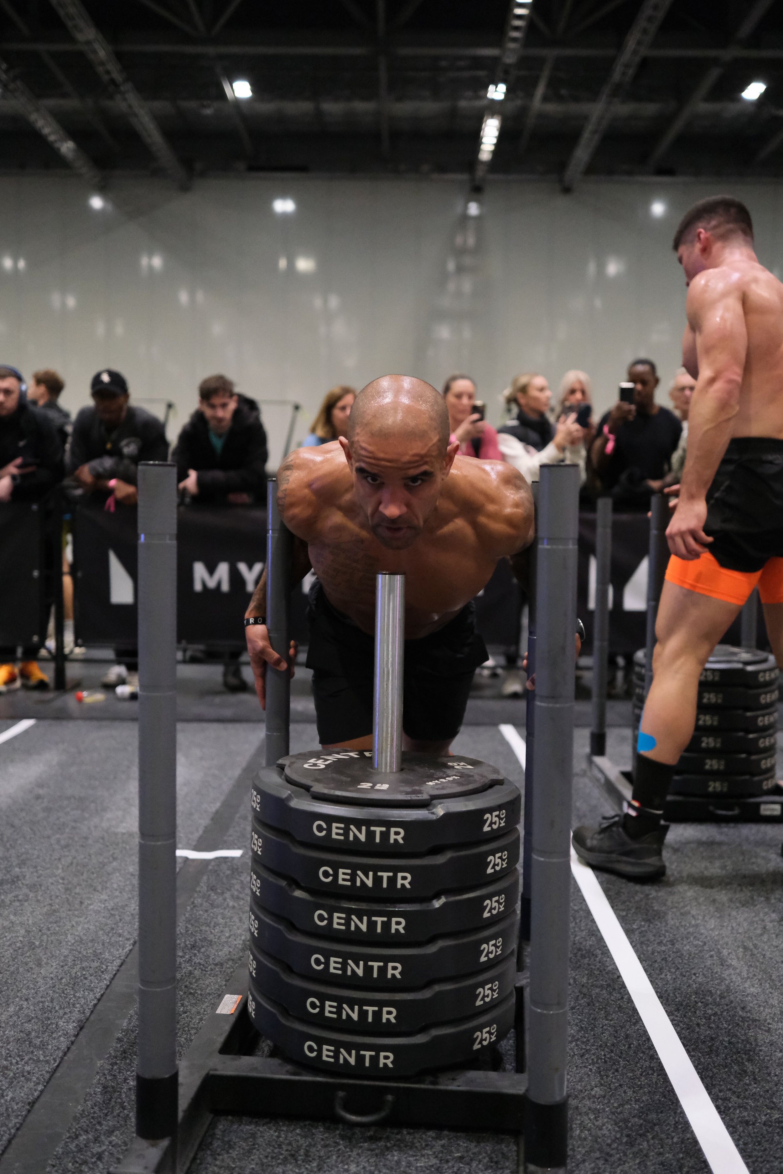 ben leacock pushing the sled in hyrox pro